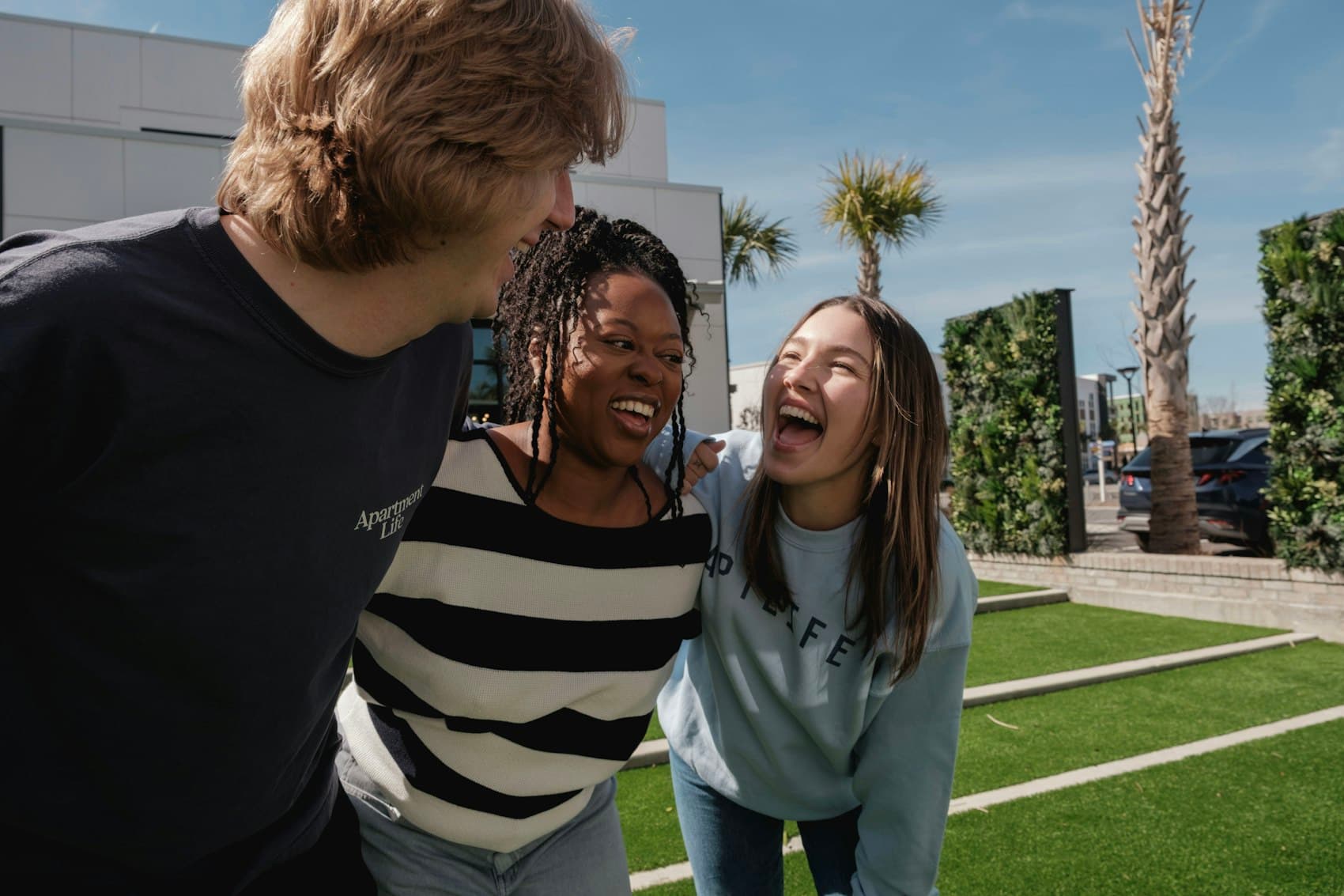 Friends standing close, laughing together